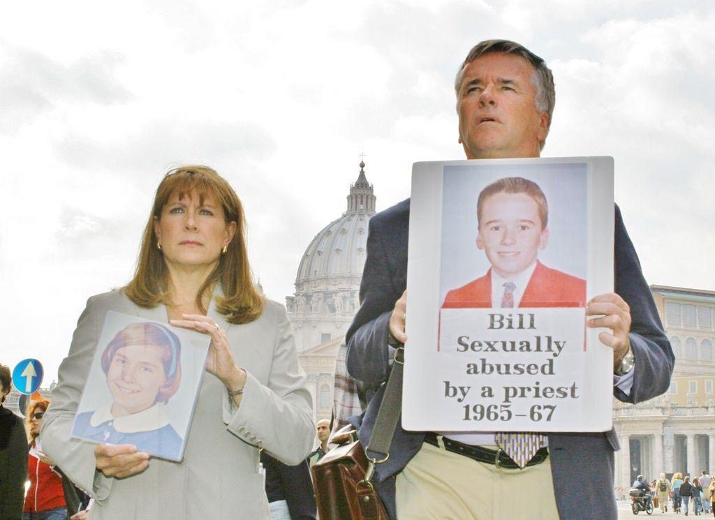 People holding sign and photo protesting