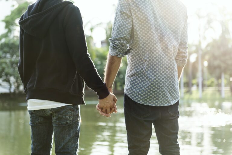 Two guys holding hands