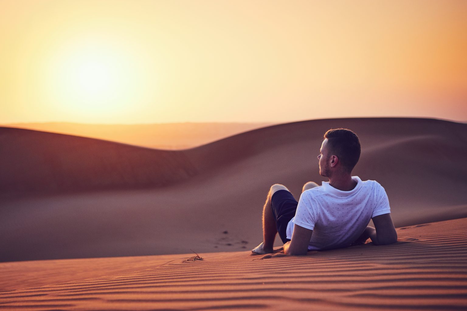 Man laying on the sand
