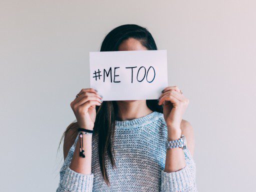 Woman holding paper with #MeToo